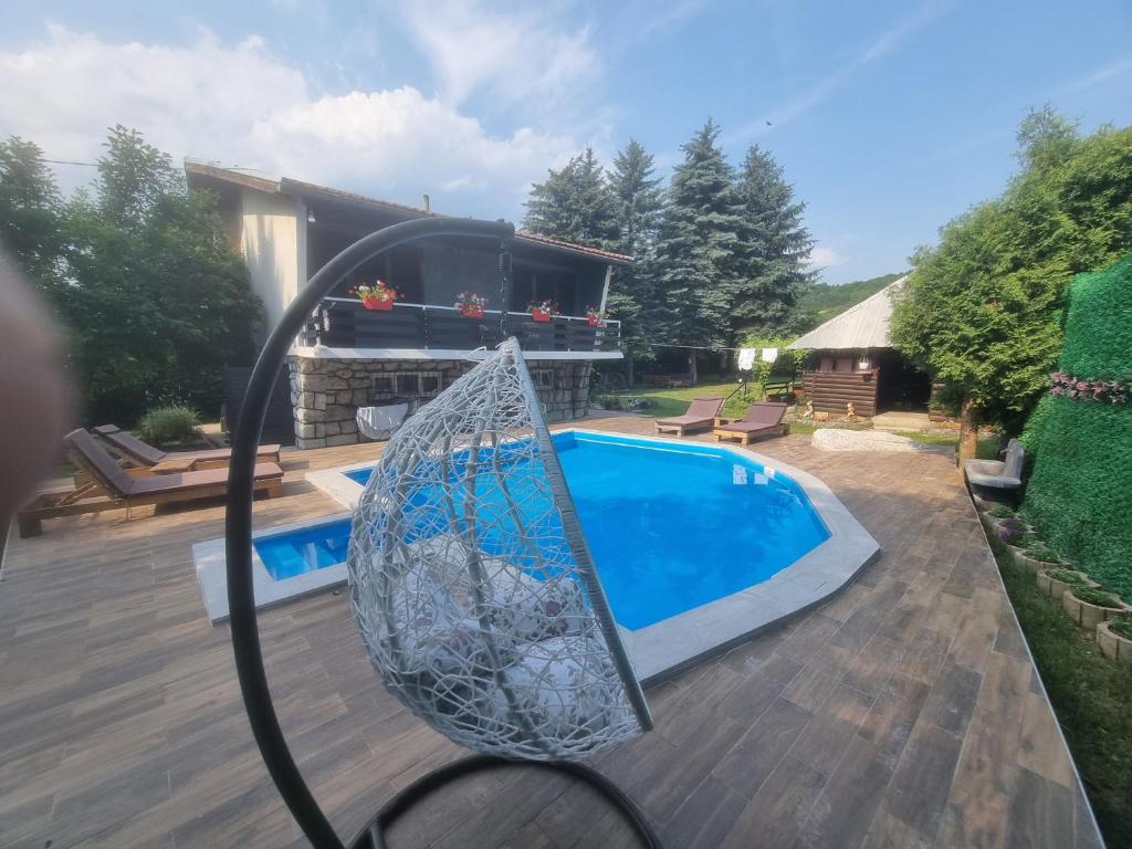 a swing in front of a swimming pool at Villa "Hipnotic" in Sarajevo