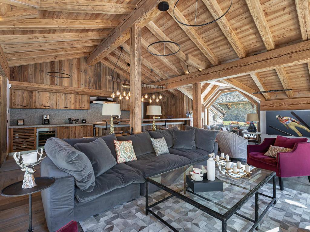 a living room with a couch and a table at Chalet de luxe familial à Val d'Isère avec spa, proche des pistes et équipements premium - FR-1-567-72 in Val dʼIsère