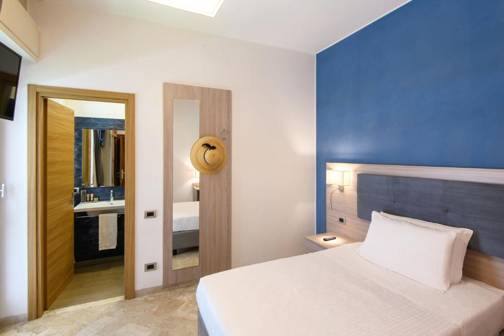 Postel nebo postele na pokoji v ubytování Hotel & Apartments Sasso