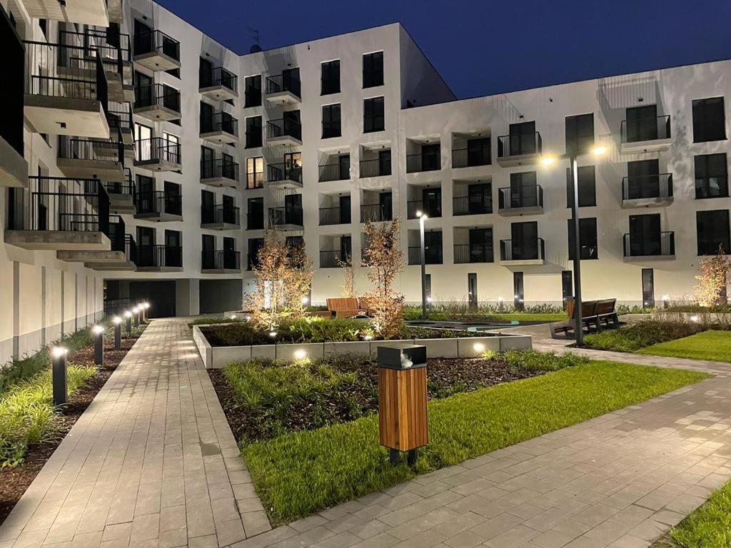 a large building with lights in front of it at Wygodne Mieszkania Nova Mikołowska 98 in Katowice