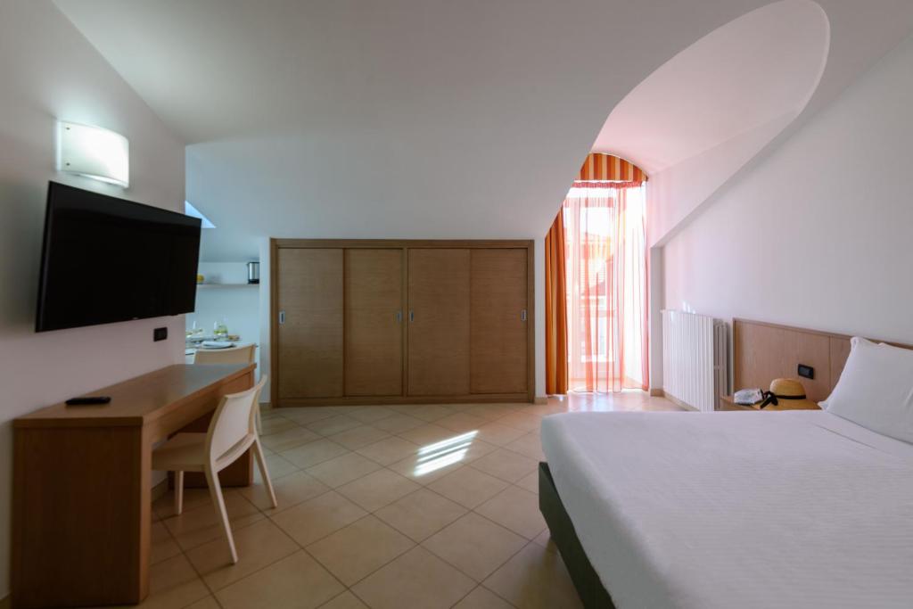 Postel nebo postele na pokoji v ubytování Hotel & Apartments Sasso