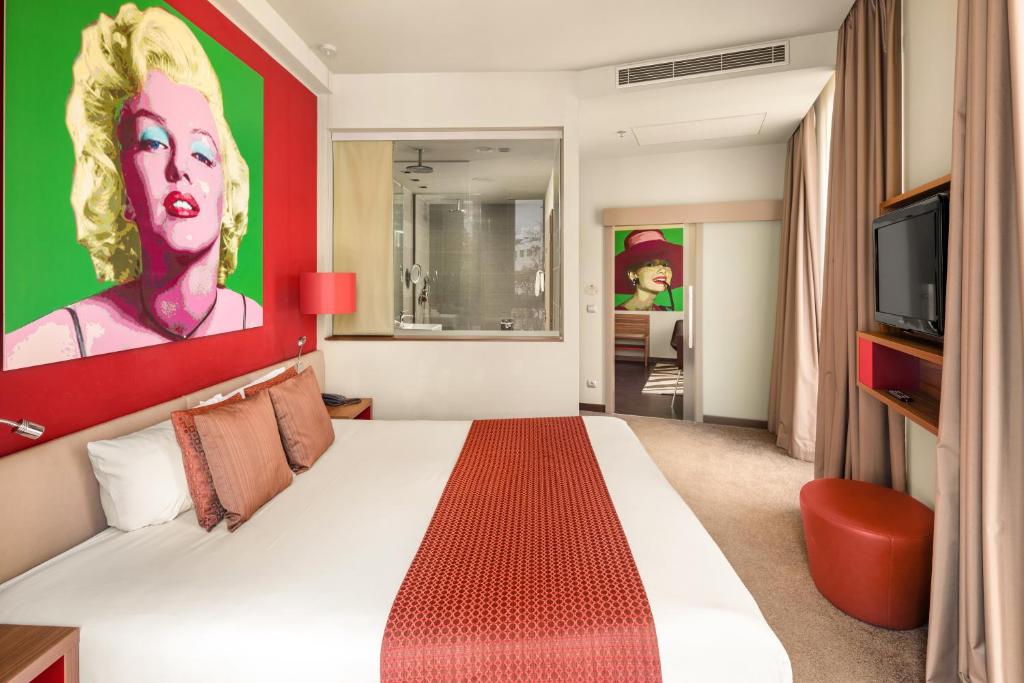 a hotel room with a bed and a tv at Clarion Congress Hotel Bratislava in Bratislava