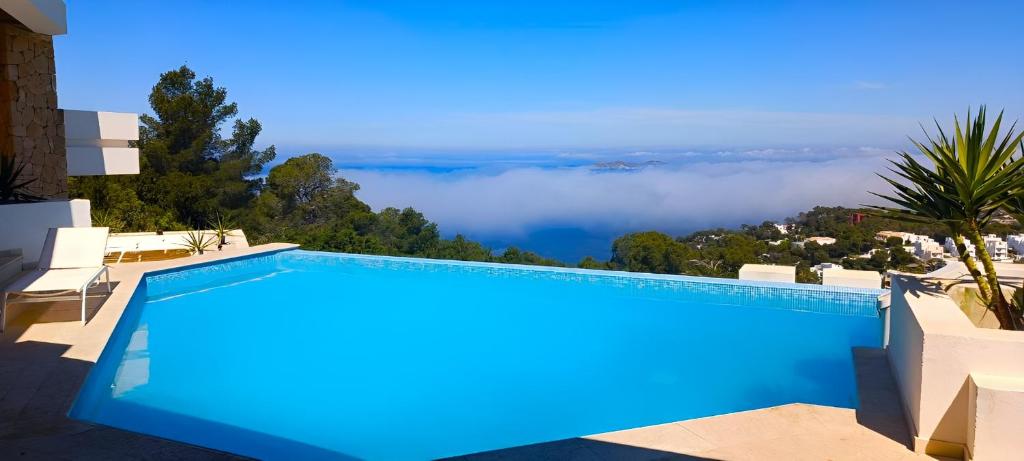 a swimming pool with a view of the clouds at Ibiza 7th Heaven Villa in Sant Josep