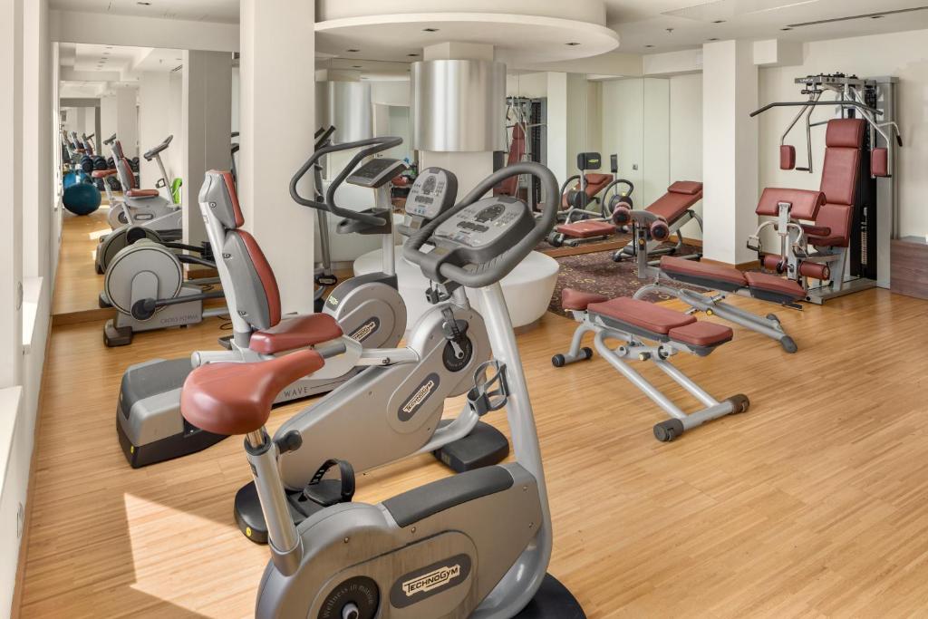 a gym with several treadmills and exercise bikes at Clarion Congress Hotel Bratislava in Bratislava