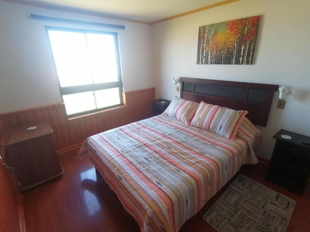 a bedroom with a bed and a window at Condominio Ilimay Las Cruces in Las Cruces
