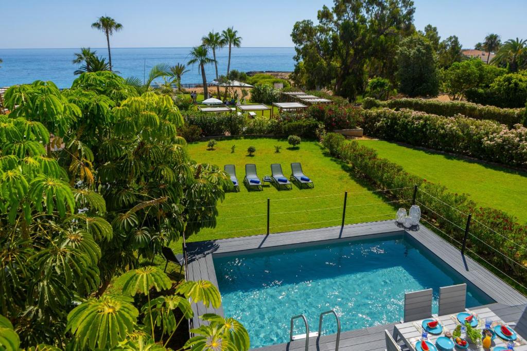 an overhead view of a swimming pool and the ocean at Protaras Sunrise Zen Seafront Villa in Protaras