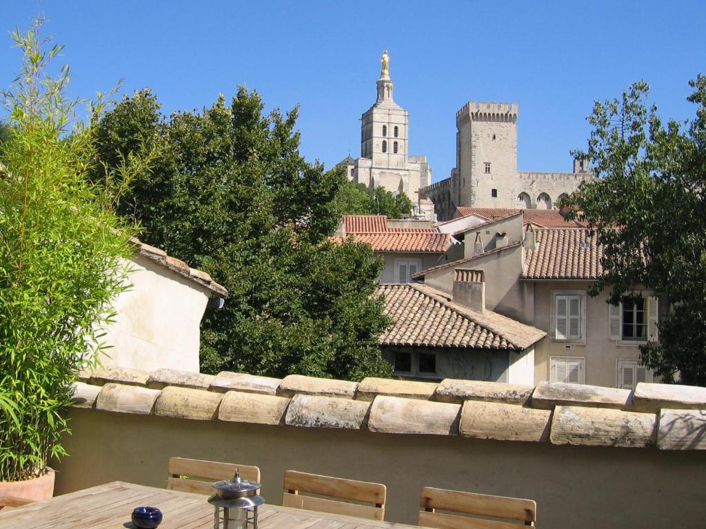 a view of a city from a balcony with a table at Le Limas in Avignon