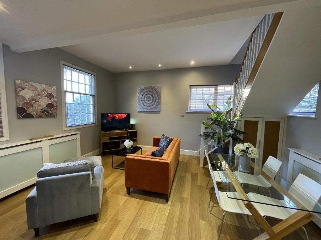 a living room with a couch and a glass table at Luxury 3-bed Victorian Townhouse Hosted by Hutch Lifestyle in Leamington Spa