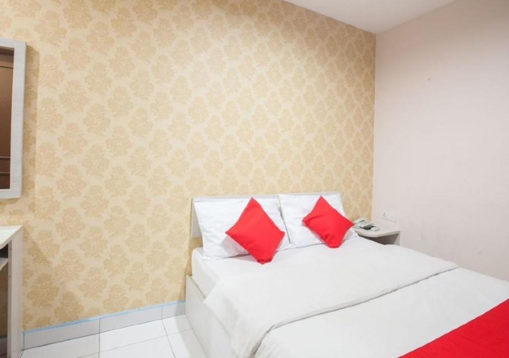 Postel nebo postele na pokoji v ubytování Hotel Pulai Ipoh