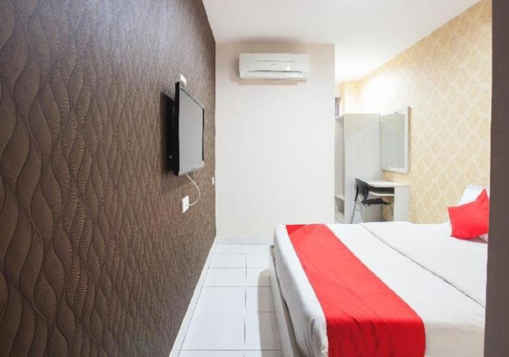 Postel nebo postele na pokoji v ubytování Hotel Pulai Ipoh