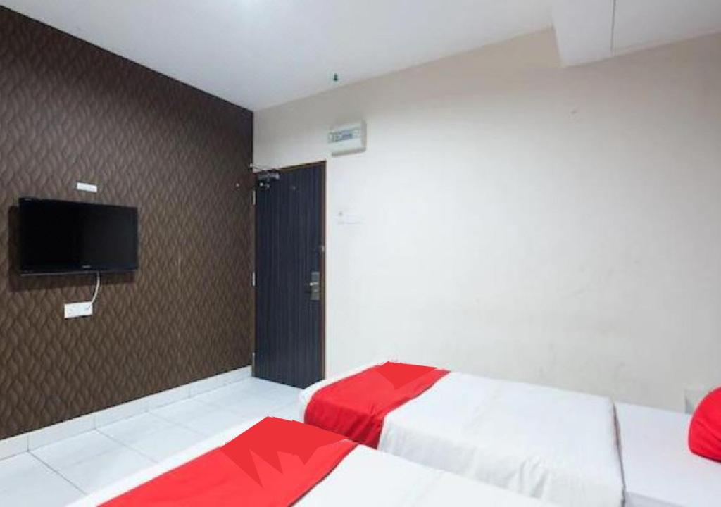 Postel nebo postele na pokoji v ubytování Hotel Pulai Ipoh