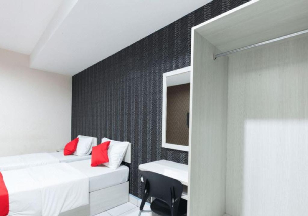 Postel nebo postele na pokoji v ubytování Hotel Pulai Ipoh