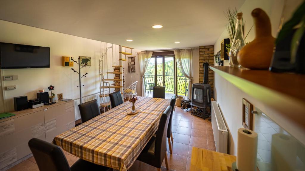 a kitchen and dining room with a table and chairs at Specious Apartment Manitu in forest countryside in Fužine