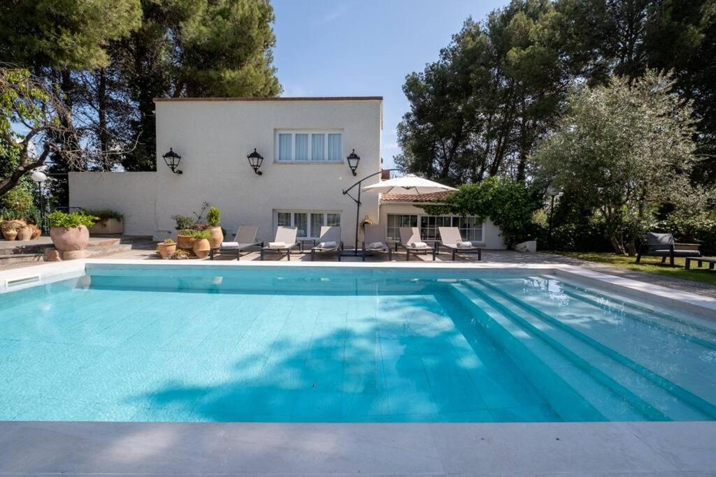 a swimming pool in front of a house at Torre Lolita - House in Lleida for 8 with pool and tennis court in Lleida