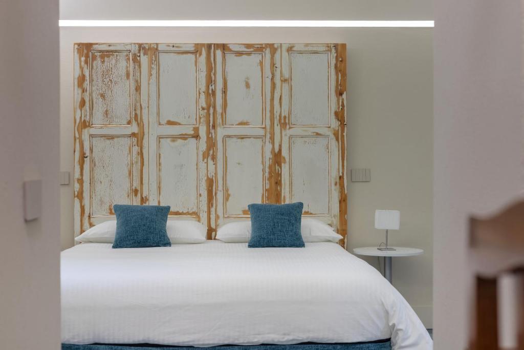 カターニアにあるBiuti Suite Apartmentのベッド1台(上に青い枕2つ付)