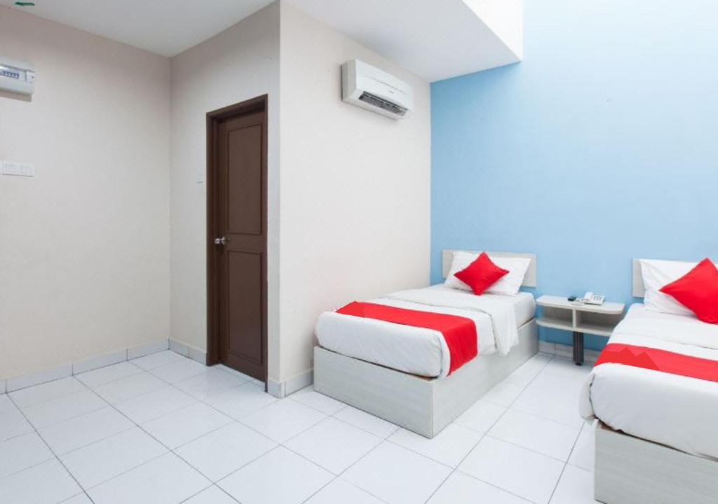 Postel nebo postele na pokoji v ubytování Hotel Pulai Ipoh