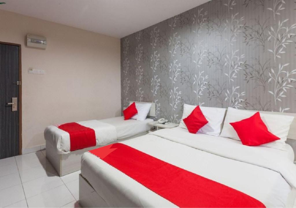 Postel nebo postele na pokoji v ubytování Hotel Pulai Ipoh