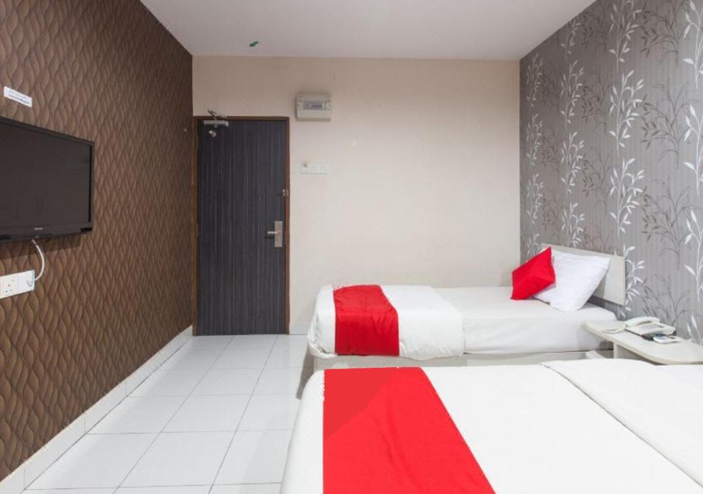 Postel nebo postele na pokoji v ubytování Hotel Pulai Ipoh