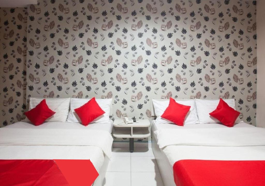 Postel nebo postele na pokoji v ubytování Hotel Pulai Ipoh