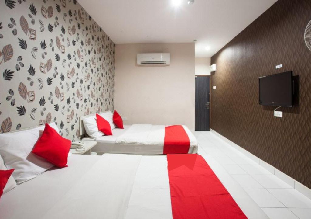 Postel nebo postele na pokoji v ubytování Hotel Pulai Ipoh