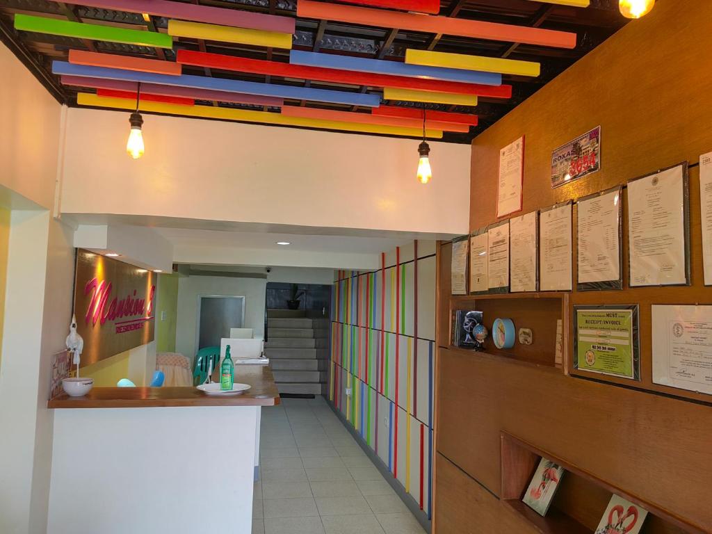 a hallway with multicolored utensils hanging from a ceiling at Mansion 8 Residences in Roxas City