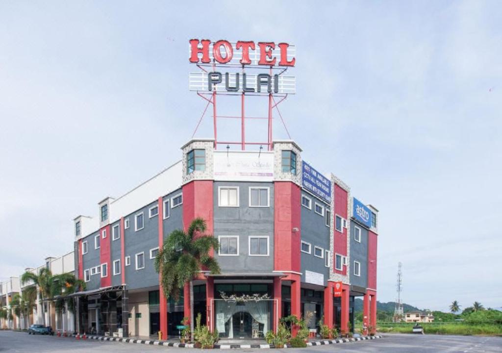 a hotel with a sign on the top of it at Hotel Pulai Ipoh in Ipoh