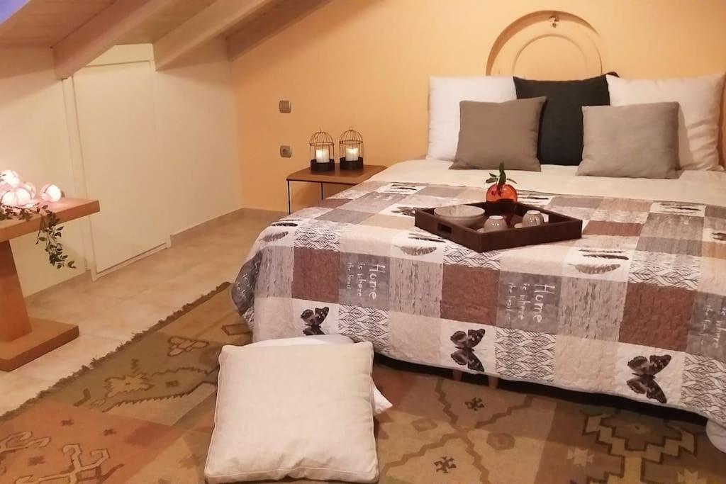 a bedroom with a large bed with a tray on it at You & Me, near the sea and Patras University in Patra