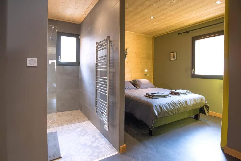 a bedroom with a bed and a walk in shower at HaKaJu Appartement 10 personnes à Val Cenis in Lanslebourg-Mont-Cenis