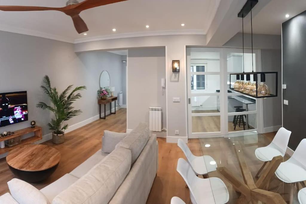 a living room with a white couch and white chairs at San Sebastian Centro Parking incluido in San Sebastián