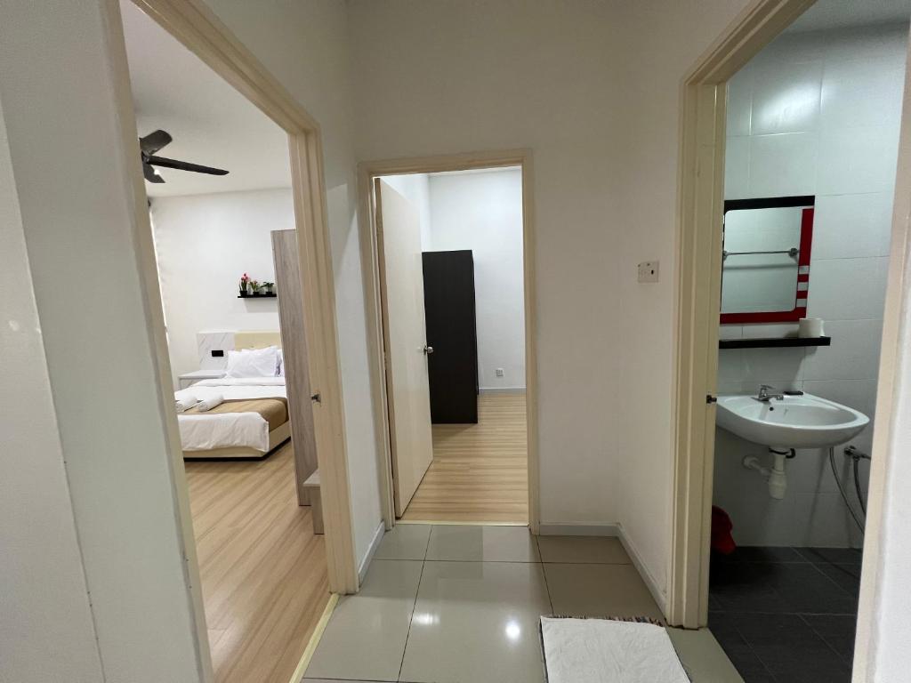 a room with a bathroom with a sink and a bed at Home Away From Home In Taiping - Newly Upgraded! in Taiping