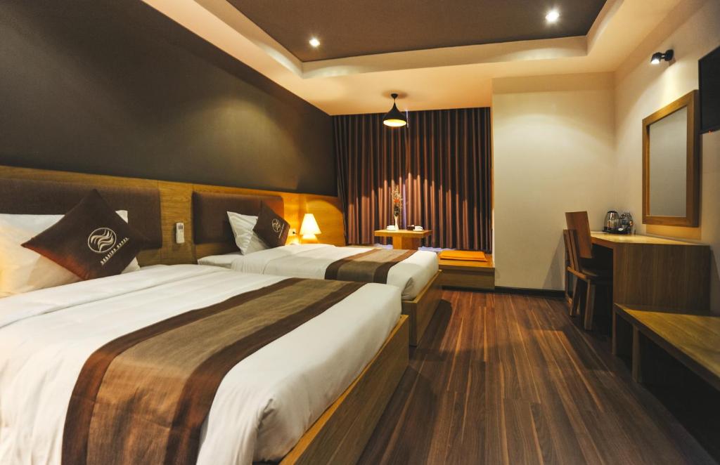 Postel nebo postele na pokoji v ubytování Seasing Boutique Hotel