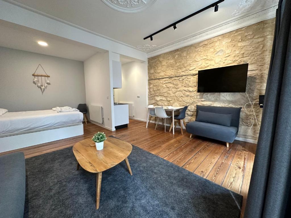 a living room with a bed and a table at Oktheway Real 45 in A Coruña