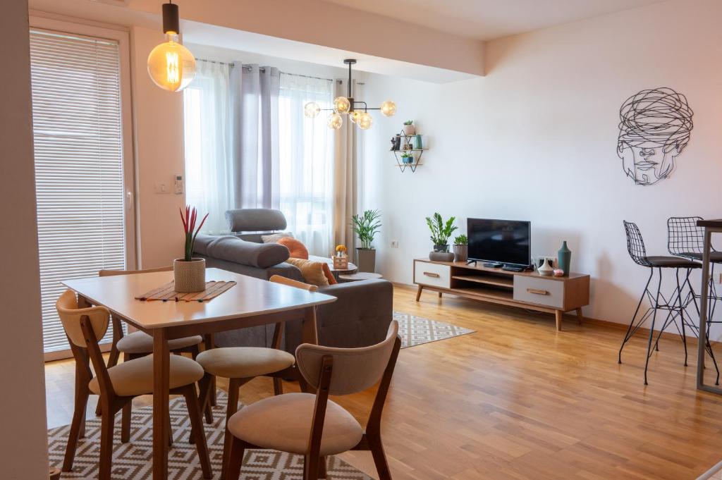 a living room with a table and a couch at Skopje Station Apartment in Skopje