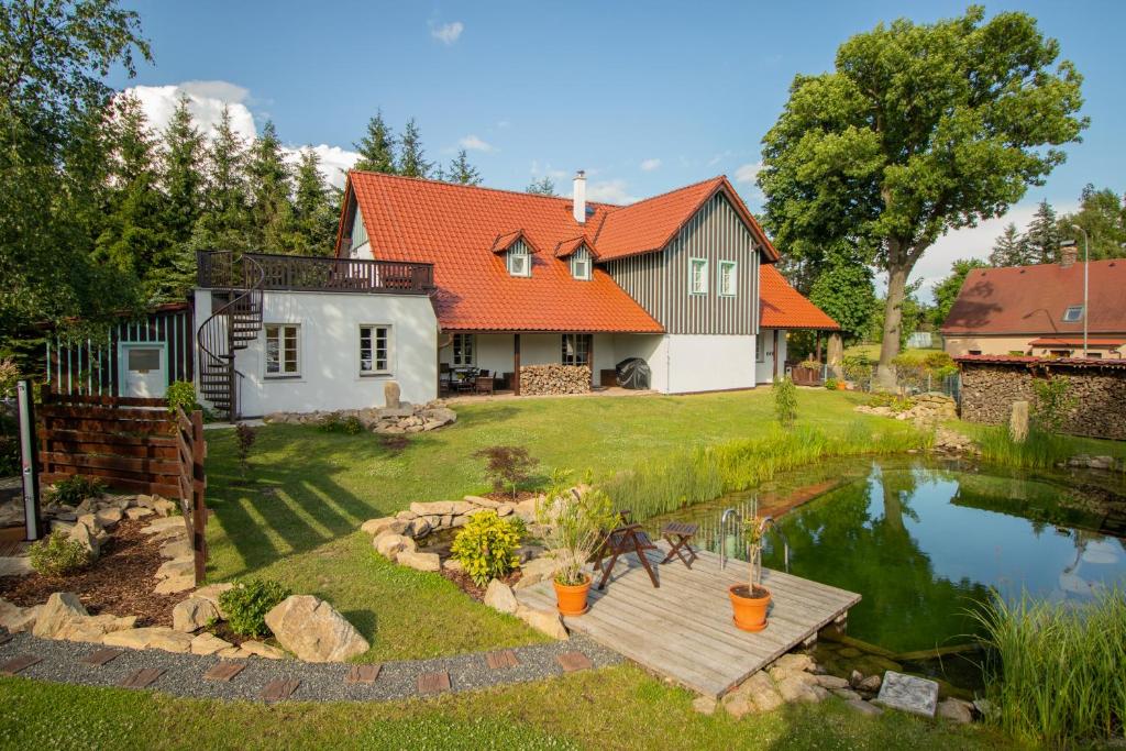 an aerial view of a house with a pond at COUNTRY HOUSE Tisá in Tisá