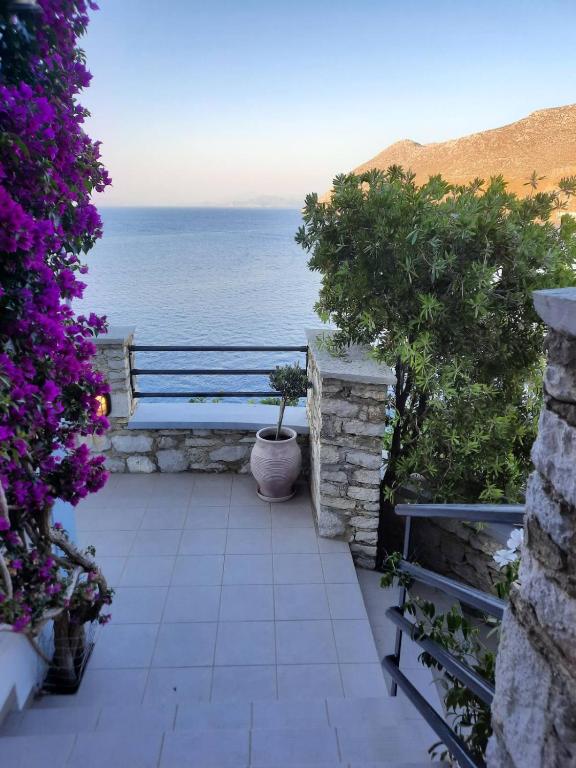 a patio with a view of the ocean at Margaritas apartments in Symi