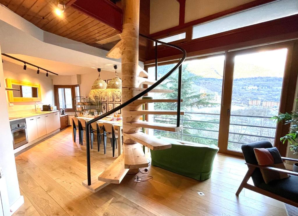 uma sala de estar com uma escada em espiral numa casa em Tuca - Triplex Priviletge con encanto em Vielha