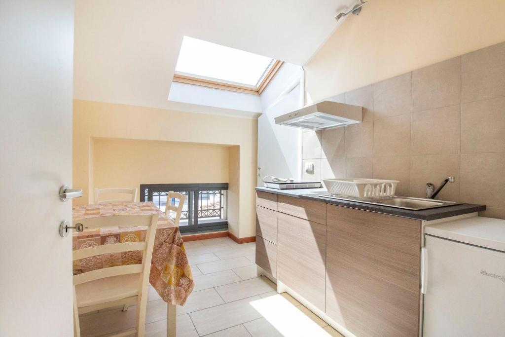 a kitchen with a sink and a counter top at Royal Playa Suite and Apartament -private parking- self chek out in Catania