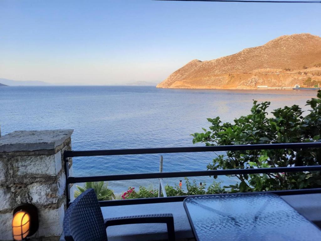 a view of the ocean from the balcony of a house at Margaritas apartments in Symi