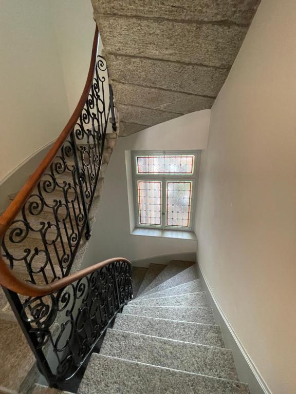 a winding staircase with a window in a house at Exclusive one room apartment next to Zürich main station in Zürich