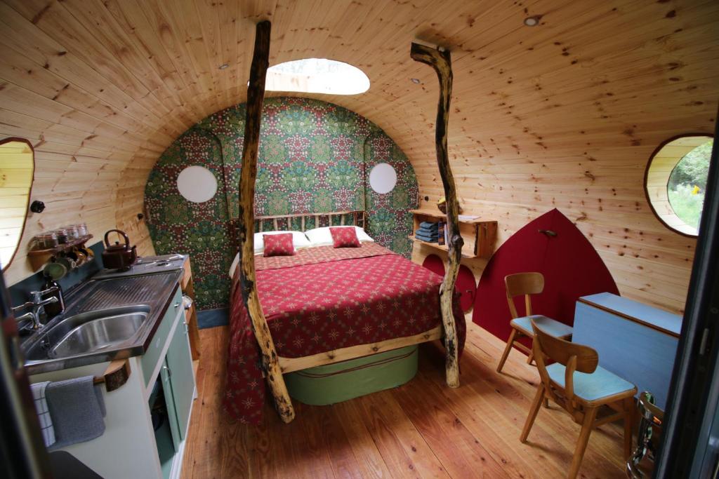 a bedroom with a bed in a small room at Caban Delor. Off-grid glamping experience. Walking distance into Caernarfon. 20-min drive to Snowdonia or Anglesey. in Caernarfon