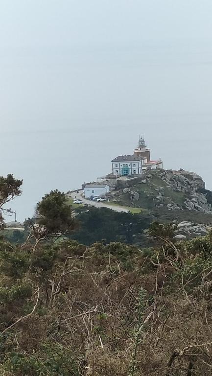 a house on top of a hill with a house at El Pommier in Fisterra