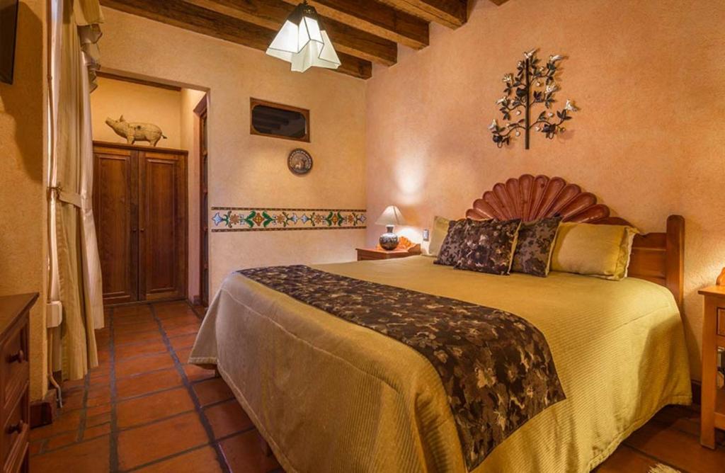 Postel nebo postele na pokoji v ubytování Hotel Pueblo Magico