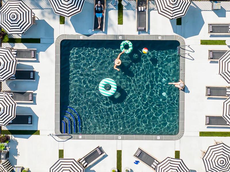 an overhead view of a pool with a person swimming at Wanderer Cottages in Kennebunk
