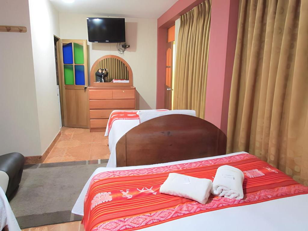 Postel nebo postele na pokoji v ubytování Hotel Colquewasi