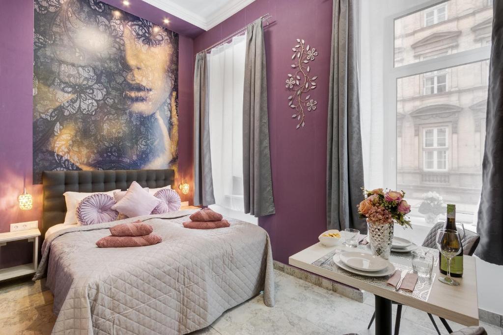 a bedroom with purple walls and a bed with brown pillows at Budapest Magic in Downtown in Budapest