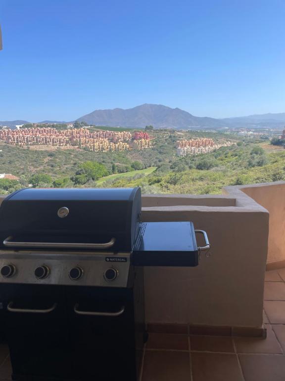 a grill on a balcony with a view at Bermeja view apartment in Manilva