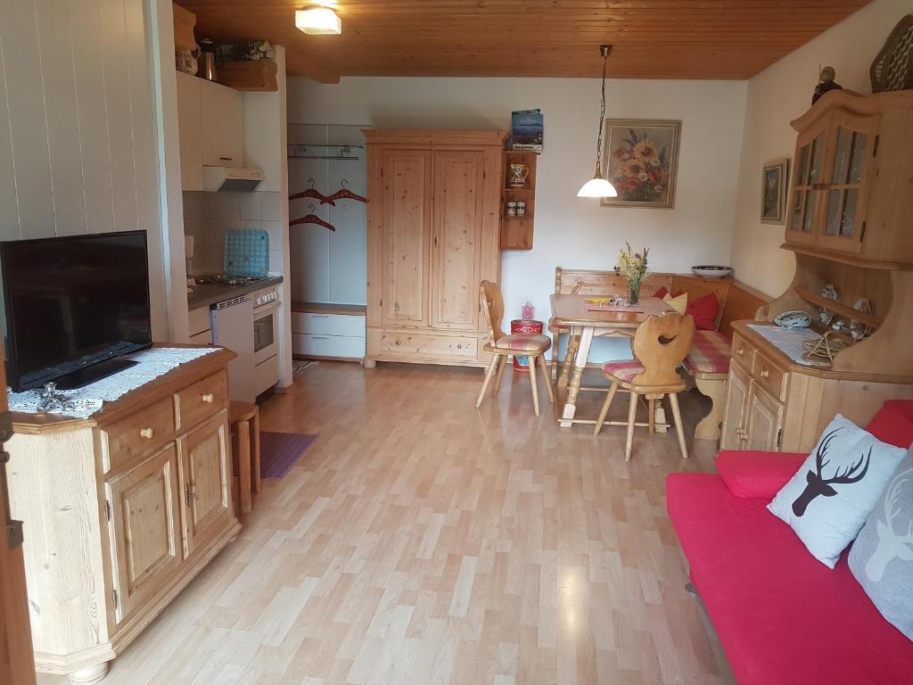a kitchen with a couch and a table in a room at Ferienwohnung am Hauchen in Reit im Winkl