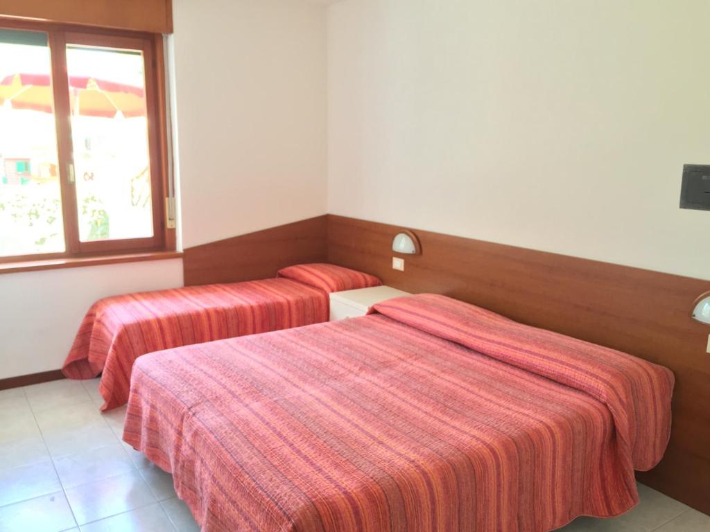 A bed or beds in a room at Bibione Residence Apartments