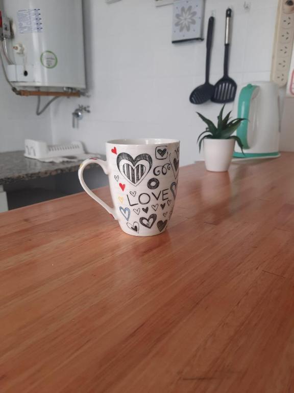 a coffee cup sitting on top of a wooden table at Mar de Anto in Puerto Madryn