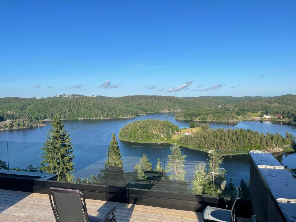 a view of a lake from the balcony of a house at VacationNorway in Froland Verk